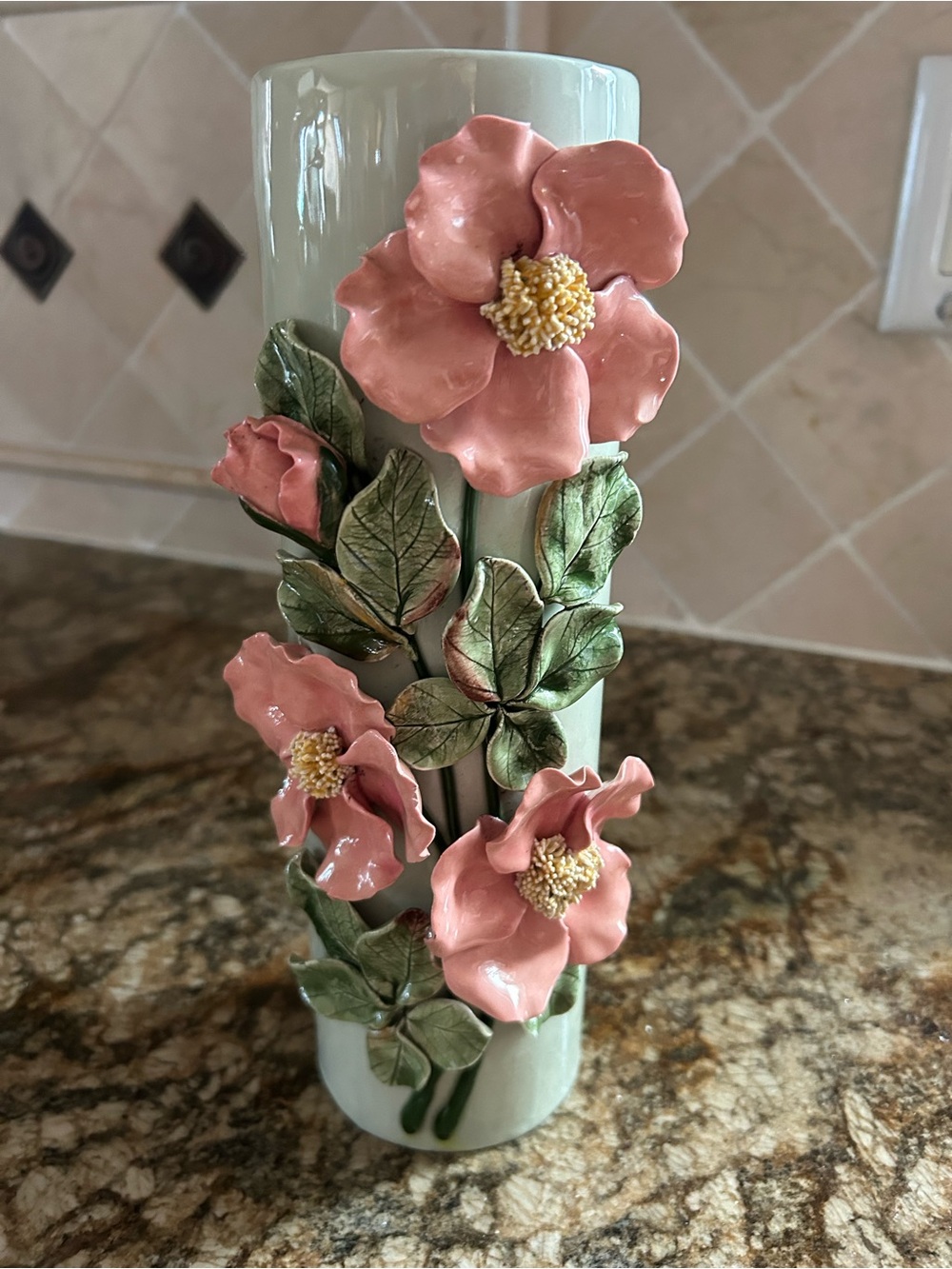 Beautiful mint green vase with pink applied flowers 10” high.